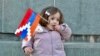 Nagorno-Karabakh - A girl holds a Karabakh flag in Stepanakert, December 25, 2022.