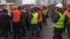 The migrants sent footage to RFE/RL that shows a group of men -- purportedly Tajik workers in Mariupol -- demanding their salaries from employers. (video grab)