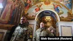 Ukrainian military personnel arrive in the Dormition Cathedral of the Kyiv-Pechersk Lavra, where Metropolitan Epiphany held a Christmas service according to the Julian calendar in Kyiv on January 7.