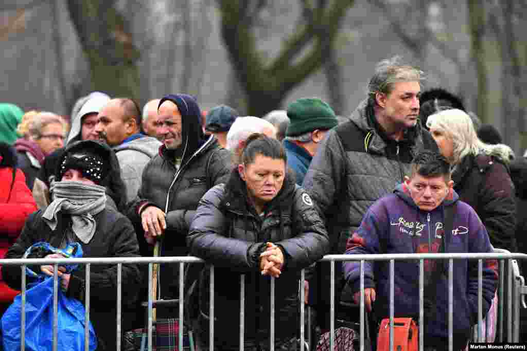 People wait in a line for free food from a charity in Budapest on December 26.&nbsp;