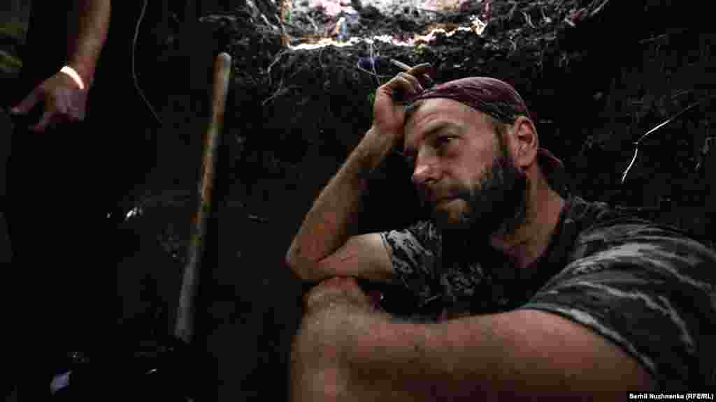 Denys, a Ukrainian serviceman who had worked as an archaeologist and teacher until Russia launched its invasion on February 24, rests between combat work as a member of a mortar unit in advanced positions in the Donetsk region on August 29. (Serhii Nuzhnenko, RFE/RL) Nuzhnenko wrote: &quot;While sitting in a trench on the front line, we talked about history, ancient times, about how Denys conducted excavations in the south and taught young people to preserve their cultural heritage. We laughed together that he is now an archaeologist in the Donbas. There is no war without black humor, and journalists in the war in certain places are the only non-military people that the fighters can meet and think back on a previous life that seems so far away.&quot;