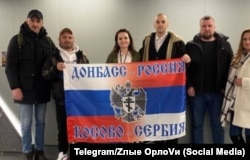 In the Vagner center, a flag was unfurled in the colors of Russia and Serbia, with the message "Donbas Is Russia, Kosovo Is Serbia." Damjan Knezevic is standing third from the right, next to Aleksandar Lisov, who heads the Russian-Serbian Center Orlovi that's behind a pro-war Telegram group known as Z-Orlovi.