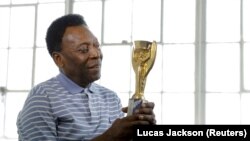 Pelé, kezében az 1958-as világbajnoki trófeával 2016. április 26-án New Yorkban