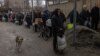 Residents line up to fill bottles with drinking water in the city of Kherson on November 24.
