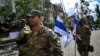 Soldiers from the Free Russia legion walk through Irpin, near Kyiv, on August 31, 2022, after signing a declaration on cooperation and coordination between volunteer units that are fighting against the Russian Army in Ukraine.