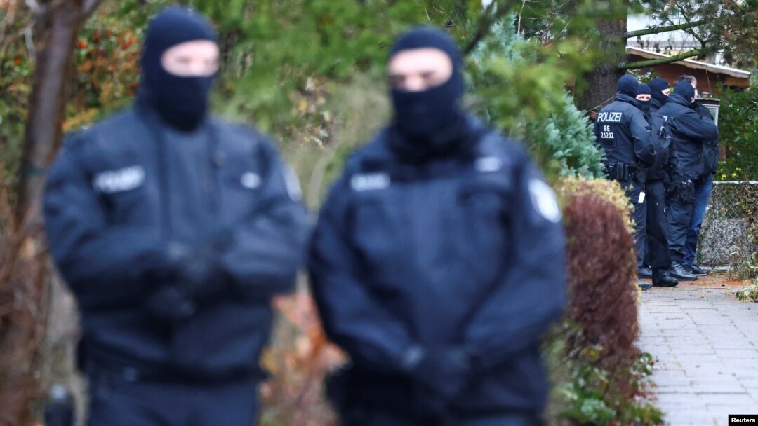 German police secure the area after 25 suspected members and supporters of a far-right group were detained during raids across Germany, in Berlin on December 7.