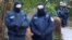 German police secure the area after 25 suspected members and supporters of a far-right group were detained during raids across Germany, in Berlin on December 7.