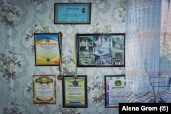 Diplomas and medals on the wall hang above the bed of Maksym, a patient of the hospital whose mother left him when he was a child. He has been looking for her ever since.