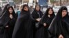 Iranian women shop at a market in the city of Najaf on December 4. 