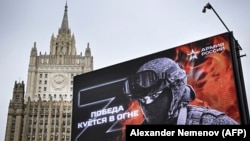 RUSSIA - The Russian Foreign Ministry building is seen behind a billboard showing Z letters (a tactical insignia of Russian troops in Ukraine) and reading "Victory is being Forged in Fire," Moscow on October 13, 2022.