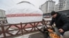 A volunteer cooks Kazakh bread outside an initiative dubbed the "Yurt of Invincibility" organized by representatives of the Kazakh diaspora in Ukraine in the town of Bucha.