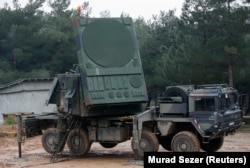 A German soldier operates a radar antenna from the Patriot system.