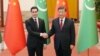 Chinese President Xi Jinping (right) and Turkmen President Serdar Berdymukhammedov shake hands at the Great Hall of the People in Beijing on January 6.