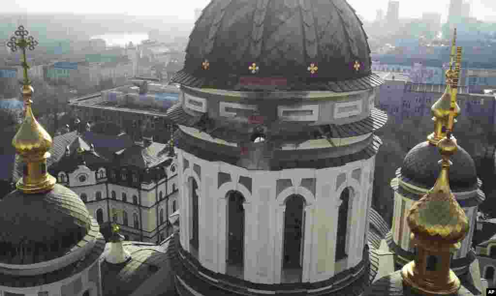 A hole from a shell explosion in the dome of a church is seen after what Russian officials in Donetsk said was shelling by Ukrainian forces in Donetsk, the capital of the Russian-controlled Donetsk region in eastern Ukraine, on December 15.