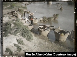 A leather tanner pauses his work to pose on a riverbank in Skopje, in what is now North Macedonia, in 1913.