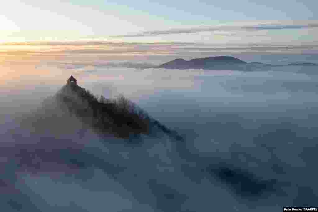 An image taken with a drone shows the fog around Salgo Castle near Salgotarjan, Hungary.