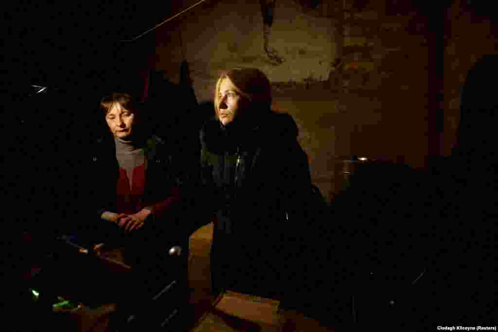 Women wait in an underground shelter in the frontline town of Bakhmut after receiving humanitarian aid as Russia&#39;s attack on Ukraine continues.