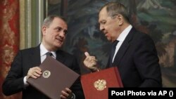 Russia - Russian Foreign Minister Sergey Lavrov, right, and Azerbaijan's Foreign Minister Jeyhun Bayramov attend a signing ceremony following their talks in Moscow, December 5, 2022.. 