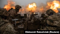Ukrainian soldiers fire an anti-aircraft gun toward Russian positions on the front line near Bakhmut on January 15.