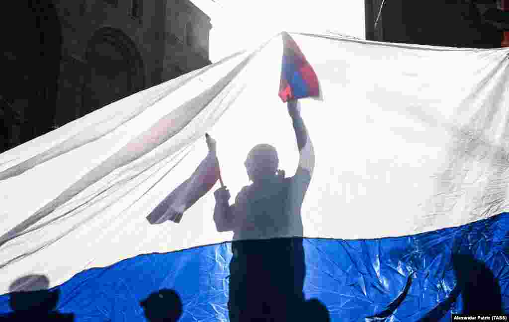 People wave Russian and Armenian flags as the city hosts a session of the Collective Security Treaty Organisation on November 23.