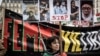 A demonstrator holds portraits of Iranian protesters Mohsen Shekari, Mohammad Mehdi Karami, Mohammad Hosseini, and Majid Reza Rahnavard, who were executed in Iran, during a rally in Lyon, France, on January 8.