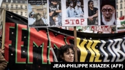 A demonstrator holds portraits of Iranian protesters Mohsen Shekari, Mohammad Mehdi Karami, Mohammad Hosseini, and Majid Reza Rahnavard, who were executed in Iran, during a rally in Lyon, France, on January 8.