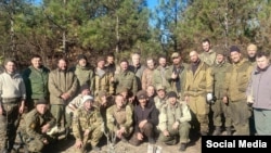 Sergei Aksyonov (center, back row), the Russian-installed head of Ukraine's Crimea region, visits Russian forces on the front line in mainland Ukraine in November.