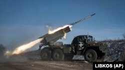 A Ukrainian Army Grad multiple rocket launcher fires missiles at Russian positions on the front line near Soledar in the Donetsk region.