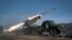A Ukrainian Army Grad multiple-rocket launcher fires missiles at Russian positions on the front line near Soledar in the Donetsk region. 