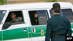 An Iranian policewoman, part of the country's morality police, looks out from a police van in Tehran. (file photo) 