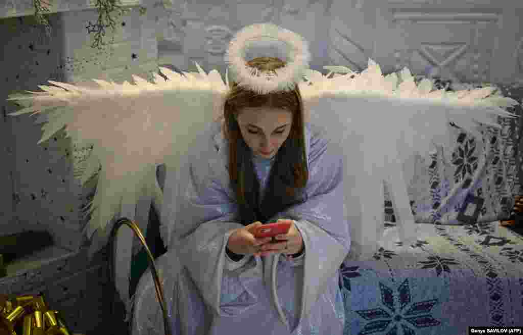 A woman dressed as an angel takes a break from greeting children.&nbsp; &quot;What happens in the library touches all aspects of people&#39;s lives,&quot;&nbsp;said Yevhenia Antonyuk of the Irpin city council.