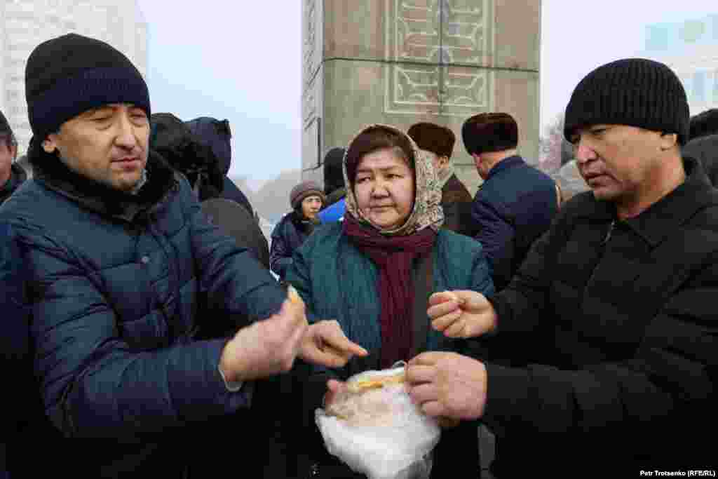A woman distributes bread after the prayer to participants. HRW, citing local independent human rights monitors, said the authorities have closed at least 32 cases relating to the deaths of 139 people. The rights groups said the &ldquo;authorities&rsquo; investigation into the events [of January 2022] has been one-sided.&rdquo;