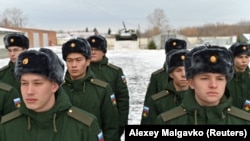Russian recruits line up at a gathering point in Omsk after being called up for military service