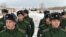 Russian recruits line up at a gathering point in Omsk after being called up for military service