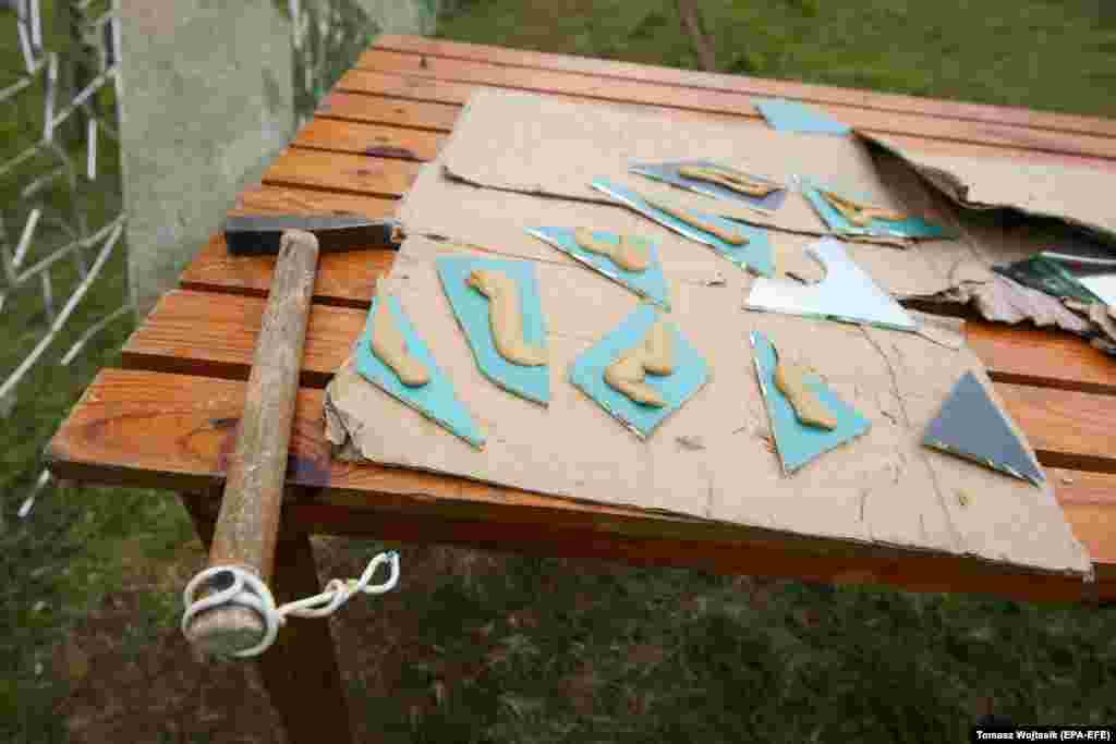 Shards of mirrors await their placement on a table at the site. Kolmykov fled to Poland after Russia&#39;s full-scale invasion of Ukraine in 2022.