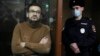 Russian opposition activist Ilya Yashin stands in a cage in a courtroom prior to a hearing in Moscow on November 29.