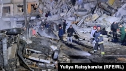 Rescuers and residents continued the search for people buried under the rubble into the evening on January 14 after a Russian missile strike hit an apartment building in the Ukrainian city of Dnipro earlier in the day.