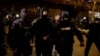 Andrew Tate (center) and Tristan Tate (center right) are escorted by police officers in Bucharest after being detained on December 29.