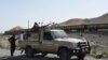 FILE: Pakistani soldiers near the site of a bomb attack on a train in Balochistan.