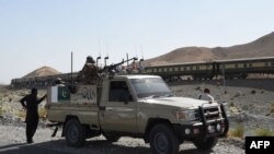 FILE: Pakistani soldiers near the site of a bomb attack on a train in Balochistan.