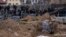 Cemetery workers exhume the corpse of a civilian killed in Bucha, outside Kyiv, from a mass grave in April.