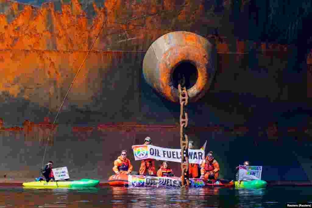 Aktivisti su se u malom čamcu vezali lancima za brod, dok su drugi u kajacima razvili transparente s natpisom &ldquo;nafta potpaljuje rat&quot;, rekla je grupa.