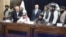 Zalmay Khalilzad (back row, center) attends the signing of an oil and gas deal with senior Taliban officials in Kabul on September 7.