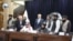 Zalmay Khalilzad (back row, center) attends the signing of an oil and gas deal with senior Taliban officials in Kabul on September 7.
