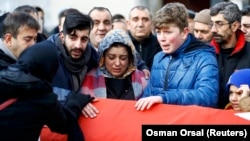 Relatives mourn at the funeral of Ayhan Arik, a victim of the Istanbul nightclub attack.