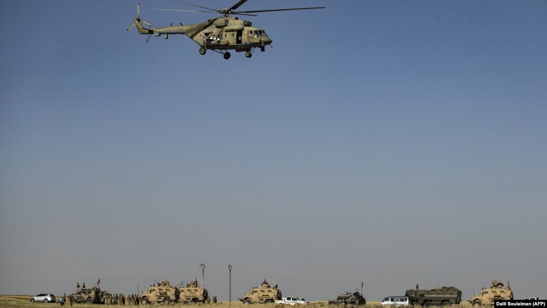 Ruski vojni helikopter iznad konvoja američkih i ruskih vojnih vozila, 2. juni, 2020. 