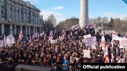 Protesters carrying Georgian flags packed the central Freedom Square on March 21 before marching toward the seat of government. 