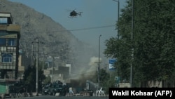 Smoke and dust rise following an air strike from an Afghan military helicopter during clashes between security forces and militants near the Eid Gah Mosque in Kabul last month.