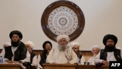 The Taliban’s Prime Minister Mohammad Hassan Akhund (center) and Minister for Promotion of Virtue and Prevention of Vice Sheikh Mohammad Khalid (left) attend a gathering at the former presidential palace in Kabul in 2022.