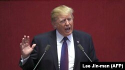 Republic of Korea -- US President Donald Trump (C) addresses the National Assembly in Seoul on November 8, 2017. Trump's marathon Asia tour moves to South Korea, another key ally in the struggle with nuclear-armed North Korea, but one with deep reservatio